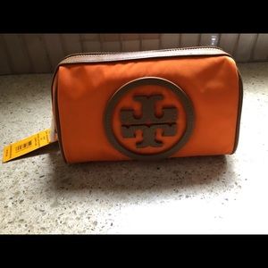 Tory Burch cosmetic case in orange and tan